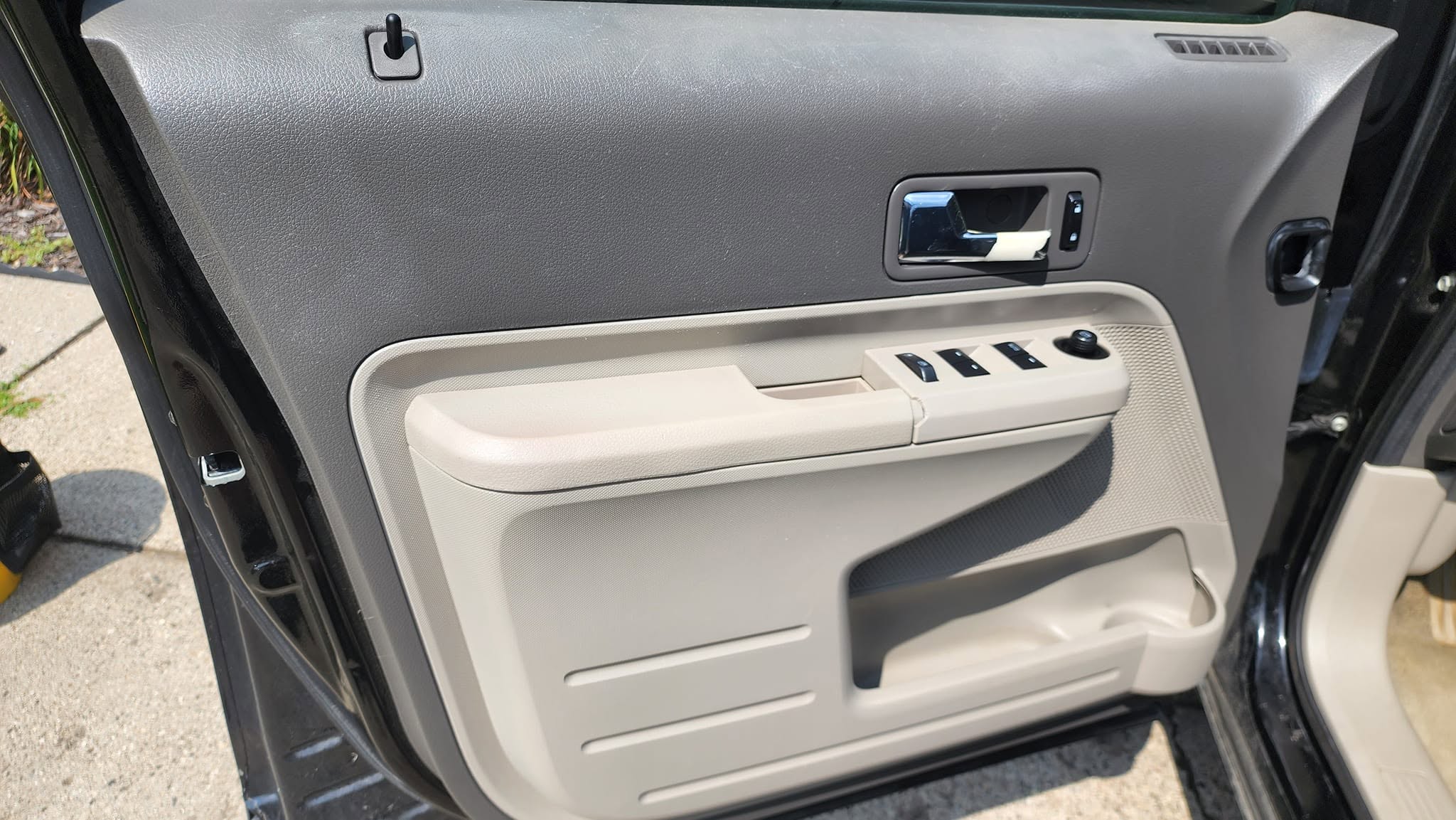 The same vehicle door panel after detailed cleaning and surface care