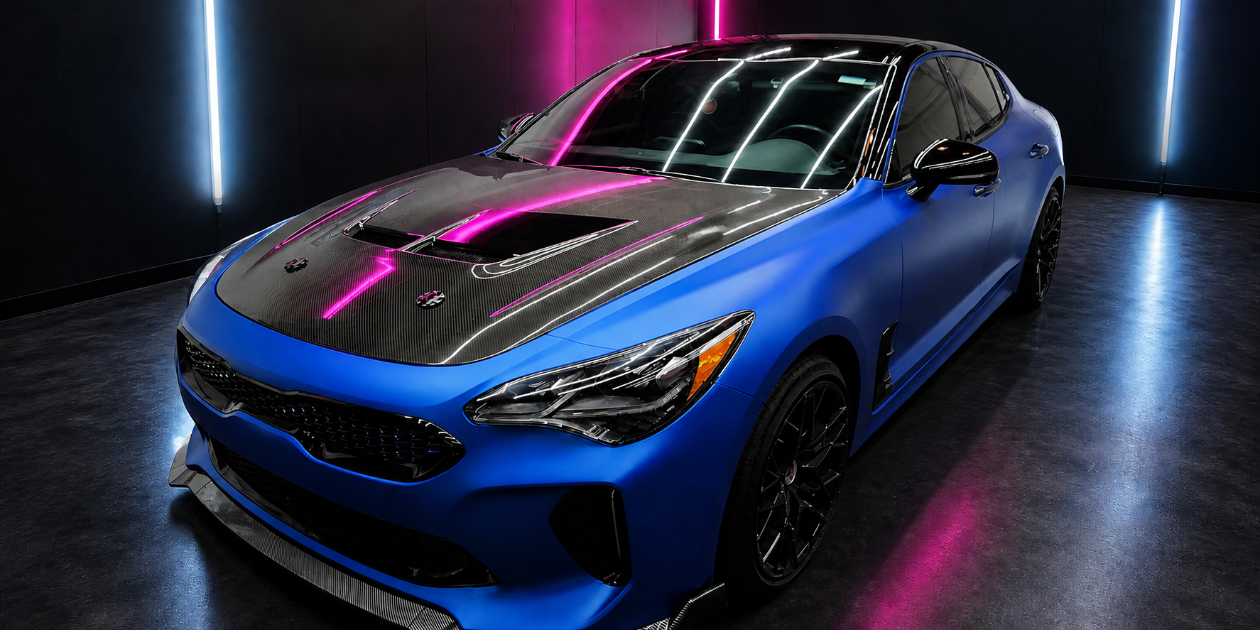 Street Details' blue Kia Stinger in a professional detailing studio